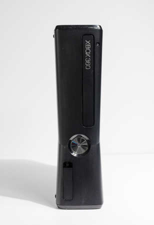 london, england, 05/05/20202 A slim line black Microsoft xbox 360 home arcade console isolated on a...