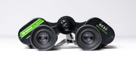 london, uk, 02/02/20202 A set of vintage old antique binoculars on a white background. Vintage retro spy ware, distance viewing, peeping and watching birds and nature.のeditorial素材