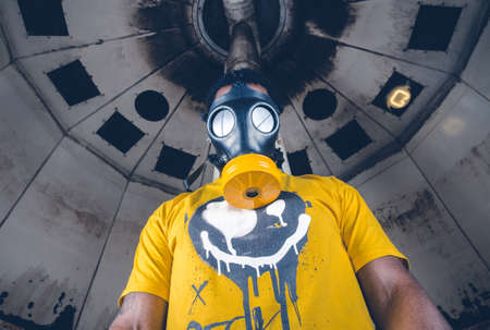 A black male with a military grade gas mask to protect himself from the corona virus covid19. Face mask used to prevent the spread of the virus. Mandatory face coverings.のeditorial素材