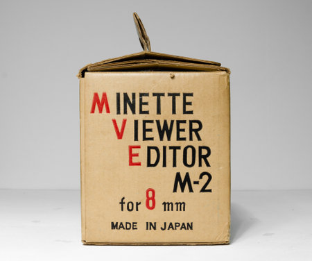 london, uk, 02/02/2020 A minette viewer editor 8mm M - 2 8mm film video reel player. Retro japanese film spool film media. Antique home movie projector media cardboard box.のeditorial素材