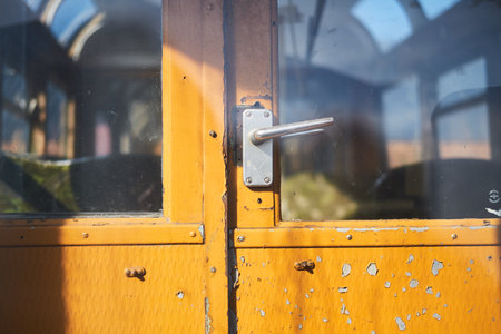 Doorhandles on an Old forgotten rusty Blackpool tram. Famous iconic seaside tourist attraction transport carriages. Rusting historic iconic trams rusting and rotting in a scrapyard.の写真素材