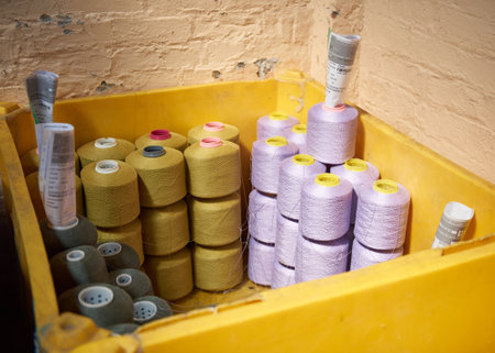 Kent, uk 01.01.2023 Raw spindles of industrial cotton in a weaving factory, hand weaving cotton for the fashion and textiles industry. Yarn weave traditional textile fabric manufacturingのeditorial素材