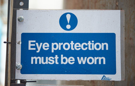 Eye protection must be worn health and safety sign to deny personal with no access clearance. Off limits in an industrial factory. danger ahead, health and safety hazard warning.の写真素材