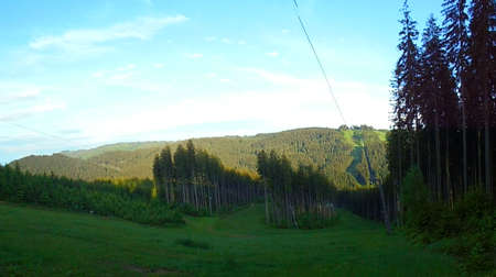 Beskydy landscape under evening sun. Fresh green mountain meadow with forests in the background.の写真素材