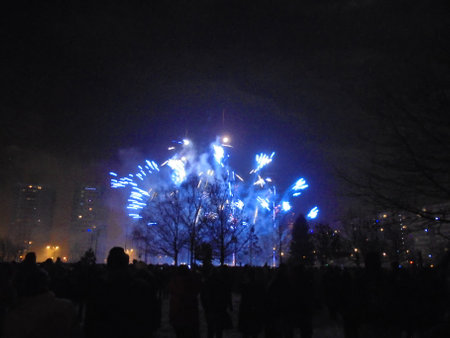 Final light explosion of first wave of blue fireworks during New Year midnight pyrotechnics show.の写真素材