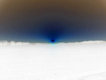 Inverted colors - Evening scenics with sun over the horizon shining in reddish color over the already dark horizon from completely bright sky.の写真素材