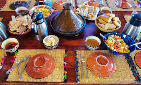 Traditional Arabic breakfast with coffee and sausages on a wooden tableの写真素材