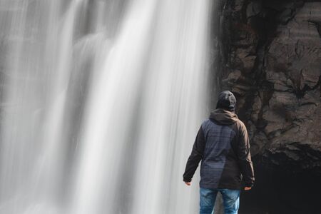 Man gazing at the waterfallの写真素材