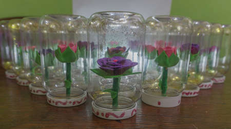 synthetic handmade flowers and introduced into a flask with waterの写真素材