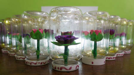 synthetic handmade flowers and introduced into a flask with waterの写真素材