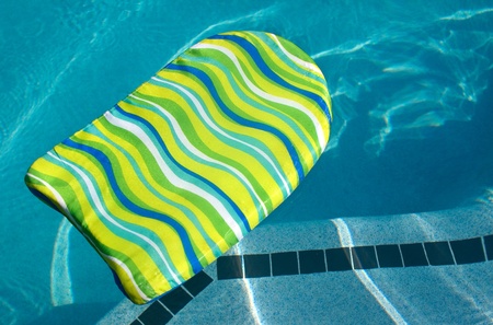 A colorful boogie kick board in swimming pool. Plenty of Copy Space.の写真素材
