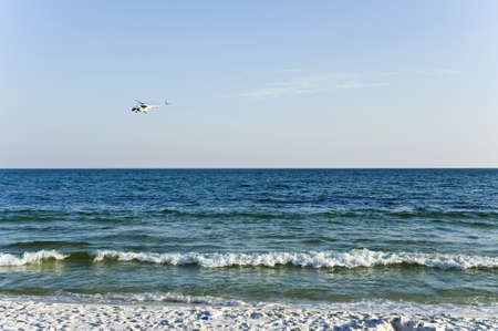 Helicopter flying on the sandy beach alongの写真素材