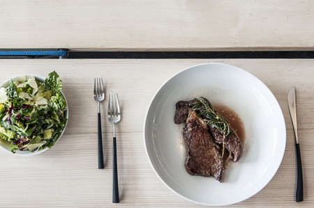 Steak and salad on two plate の写真素材