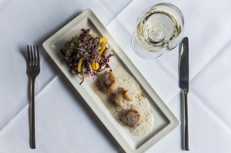 Scallop with salad and white wineの写真素材