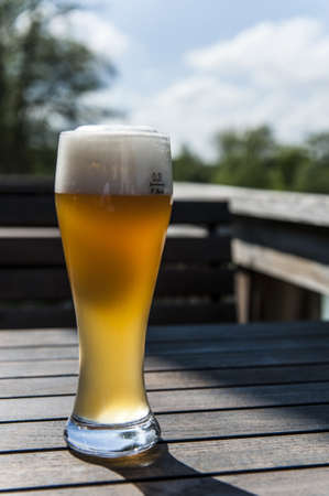 A glass of wheat beer on a tableの写真素材