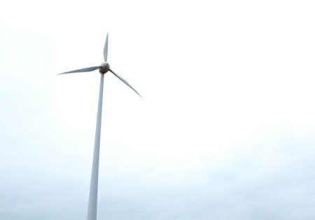 Wind turbine over the sky background の写真素材