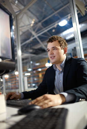 Attractive young man is working in the bank  Shallow depth of field 