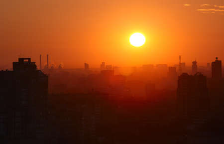 Sunrise over the city. High angle. Aerial view. The roofs of the houses lit by soft warm light. Moscow, Russia.の写真素材