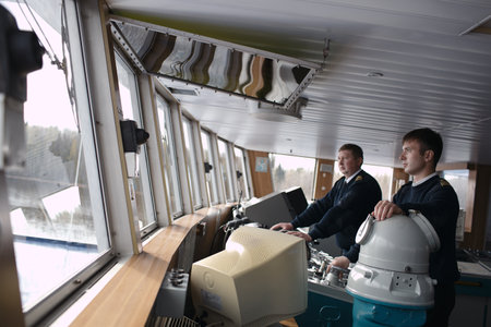 SAINT-PETERSBURG - May 11:  Second Navigational Officer and skipper are driving the cruise liner on the river Volga on May 11, 2013 in Saint-Petersburg, Russia.のeditorial素材