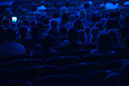 Audience in the cinema  Silhouette shot from back in blue light のeditorial素材