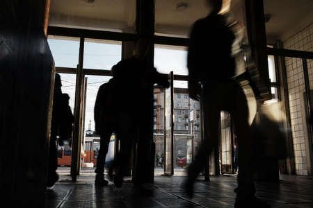 Undeground station entrance in Moscow. Silhouettes of unrecognizable people coming in open doors.の写真素材