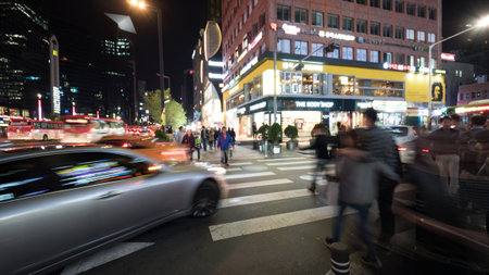 SEOUL, SOUTH KOREA - OCTOBER 22, 2015: Pedestrians crossing the road on zebra in big night illuminated cityのeditorial素材