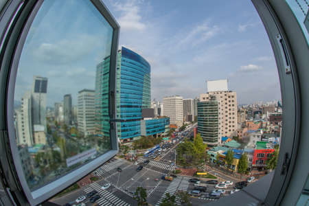 Wide angle shot of city panorama with intense car traffic on the streets. View from the window to...