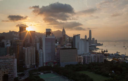 Hong Kong panorama at sunset. Cityscape with high-rise buildings and water transport traffic in the harbourの写真素材