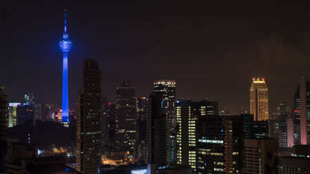 Kuala Lumpur at night, Malaysia. Illuminated city with luminous blue colored Menara KL Towerの写真素材