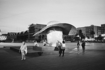 VALENCIA, SPAIN - DECEMBER 15, 2018: Evening retro style black and white shot of people taking...