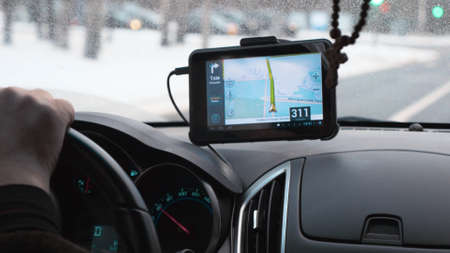 Close-up shot of car driving with GPS device over the dashboard showing a route