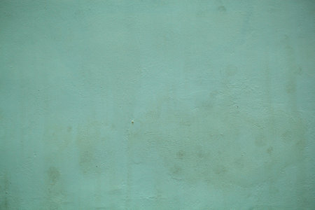 Dull forest green painted wall background texture with a close up on the surface in a full frame...