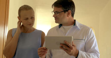 Business People with Tablet PC Walking along the Passage