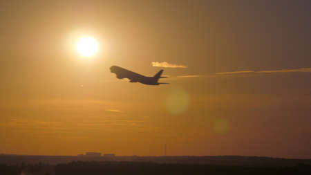 Airplane takeoff at sunset