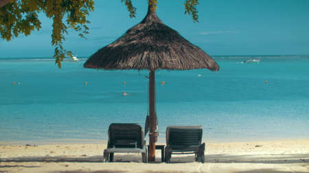 Ocean coast with chaise longues and sun umbrellaの写真素材