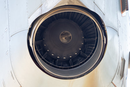 Close macro view of turboprop engine intake showing fan blades and circular frame