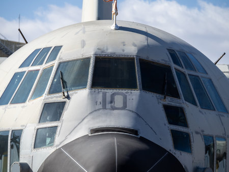 Close-up of flight deck glazing and upper fuselage of an old military transport aircraft kept...