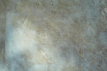 Old concrete surface with grainy texture and light stains under natural light