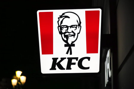 VALENCIA, SPAIN - FEBRUARY 20, 2026: Close view of KFC illuminated outdoor signage. KFC is the world...