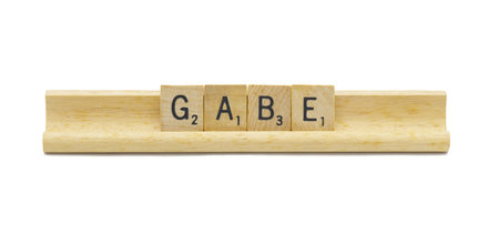 Miami, FL 4-18-24 popular baby boy first name of GABE made with square wooden tile English alphabet letters with natural color and grain on a wood rack holder isolated on white backgroundの写真素材