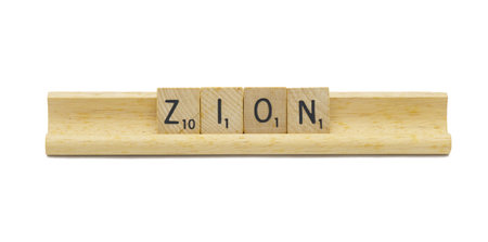 Miami, FL 4-18-24 popular baby boy first name of ZION made with square wooden tile English alphabet letters with natural color and grain on a wood rack holder isolated on white backgroundの写真素材
