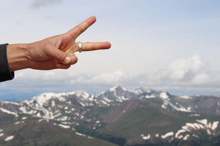Peace sign displayed from atop a summit in the Rocky Mountains.の写真素材