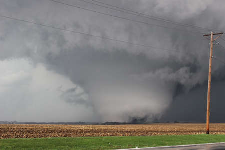 A massive, destructive tornado scours the farmland in Illinois.の写真素材