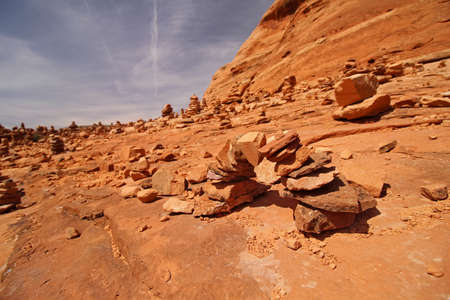 A small arch made of rocks, constructed by hikers in the desert.