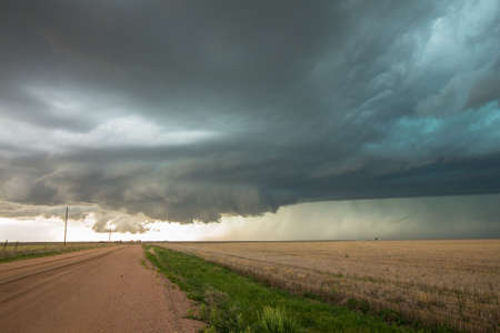 A wall cloud forms underneath a tornadic supercell thunderstorm as it gathers strength.