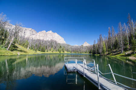A pristine alpine lake in Wyoming with a small pier.の写真素材