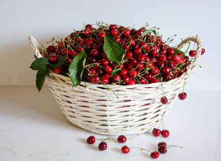 White basket with cherriesの写真素材