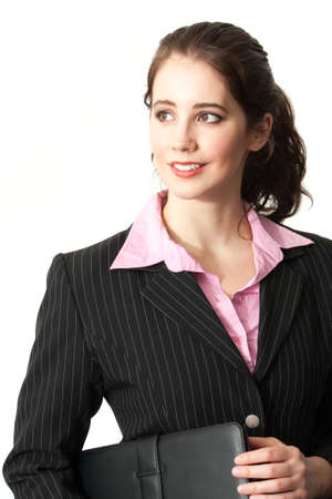 Waist up portrait of a pretty young professional woman in a pin-striped suit holding a portfolioの写真素材