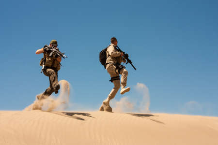 The Special Operations agents in action, jump and cover in the desert sands.