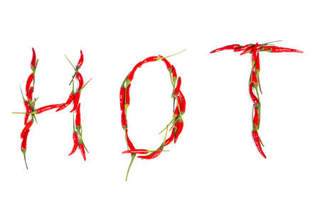 Fresh hot red chilis spell out the word hot on a white backgroundの写真素材